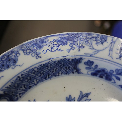 56 - A Chinese blue and white dish with floral and scrolled decoration with seal mark to base, 7 1/2