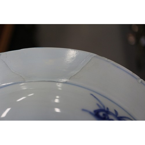 56 - A Chinese blue and white dish with floral and scrolled decoration with seal mark to base, 7 1/2