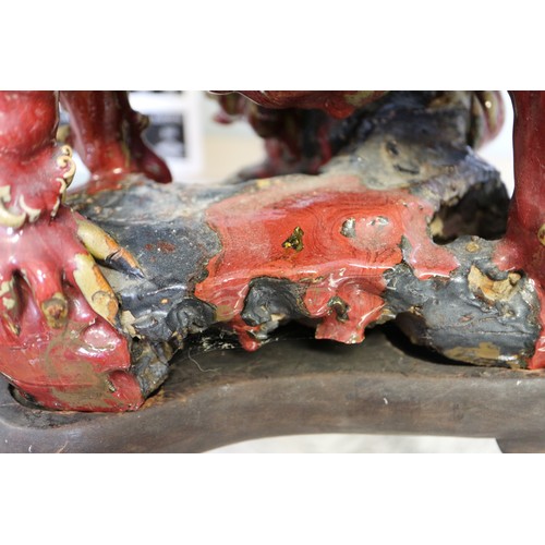 62 - A Chinese red and brown glazed porcelain model of a Dog of Fo, on hardwood stand, 16