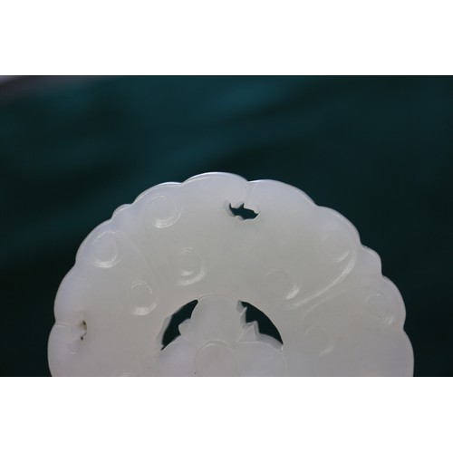 84 - A Chinese carved pale jade pendant, 2 1/4