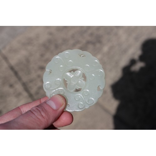 84 - A Chinese carved pale jade pendant, 2 1/4