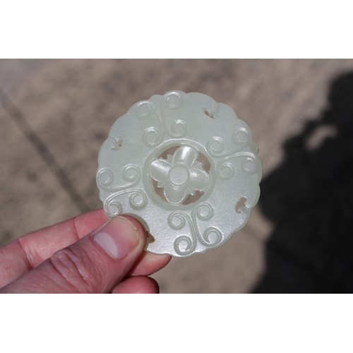 84 - A Chinese carved pale jade pendant, 2 1/4