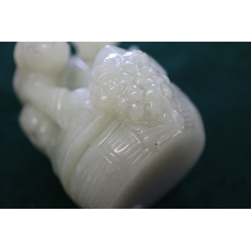 85 - A Chinese carved pale jade figure group, 2 1/2