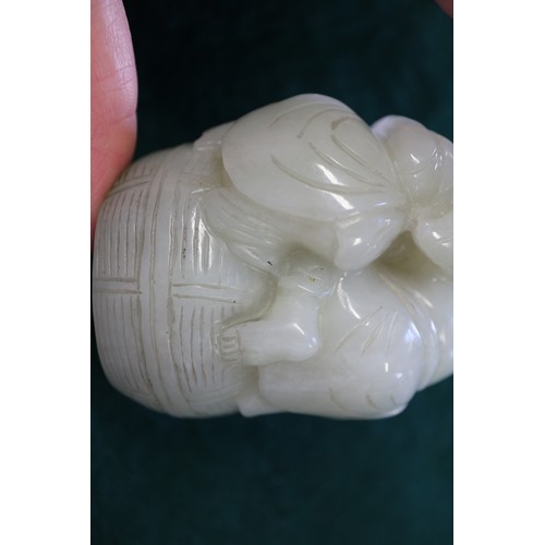 85 - A Chinese carved pale jade figure group, 2 1/2