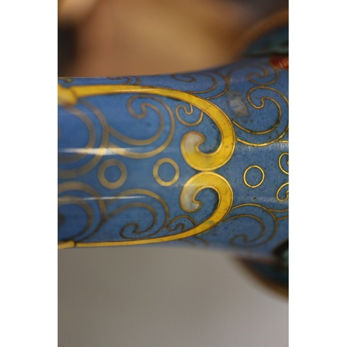 88 - A Chinese cloisonne bulbous bottle neck vase with floral and scrolled designs on a blue ground, 8