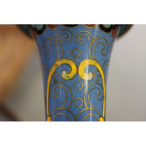 88 - A Chinese cloisonne bulbous bottle neck vase with floral and scrolled designs on a blue ground, 8