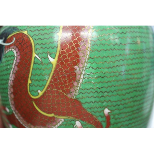 90 - *A cloisonne vase with dragon decoration on a green ground, 9 1/2