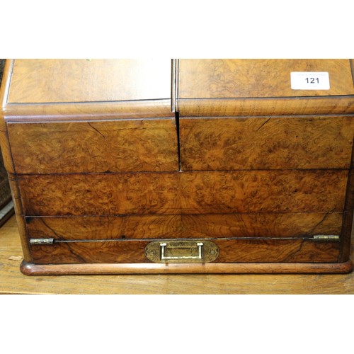 121 - A 19th century burr walnut desk tidy enclosed two doors with calendar cards over writing slope drawe... 