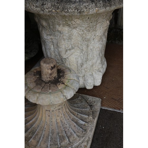 711 - A pair of cast stone campana urns with figure decoration, on square bases, 24