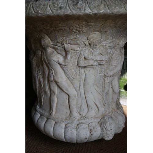 711 - A pair of cast stone campana urns with figure decoration, on square bases, 24