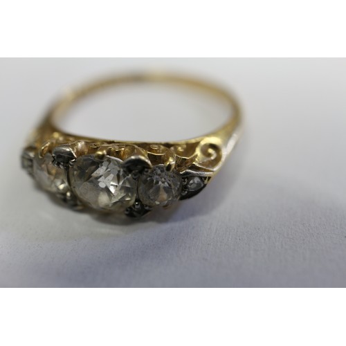 392 - A yellow metal and diamond three-stone dress ring, stamped 18ct and Platinum, size O, 3.6g