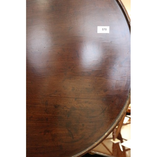 570 - A George III mahogany single-piece circular tilt top table, with bird cage, on turned column and tri... 