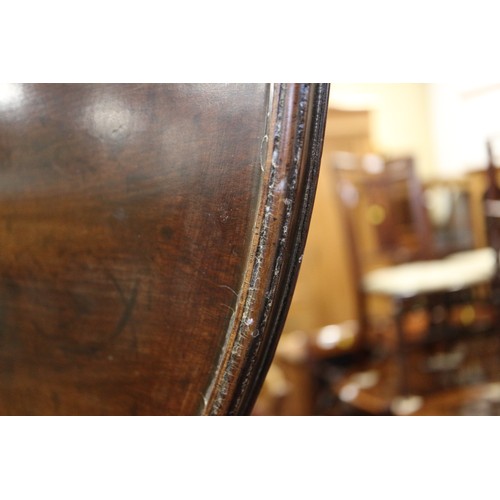 570 - A George III mahogany single-piece circular tilt top table, with bird cage, on turned column and tri... 