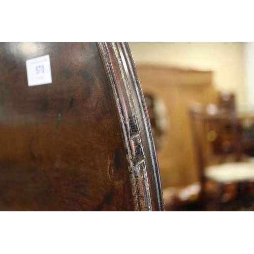 570 - A George III mahogany single-piece circular tilt top table, with bird cage, on turned column and tri... 