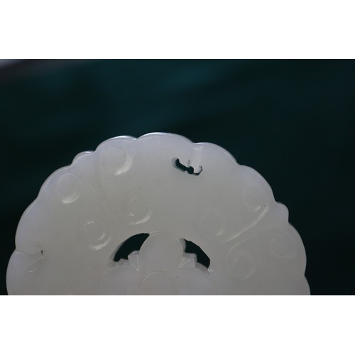 88 - A Chinese carved pale jade pendant, 2 1/4