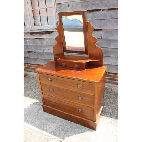 525 - An Edwardian walnut dressing chest, fitted mirror over jewel drawer and three graduated long drawers... 