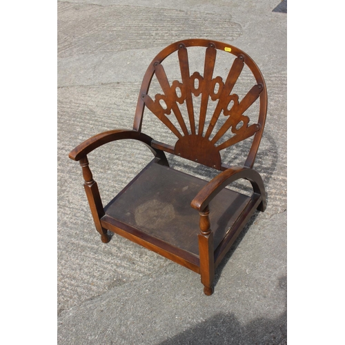 600 - An Art Deco style low seat armchair with panel seat