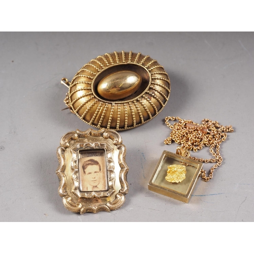 334 - A late Victorian yellow metal brooch, a memento brooch and a golden nugget, in a pendant, on fine ch... 