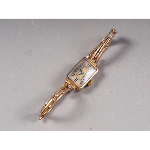 378 - A lady's 9ct gold cased wristwatch with silvered dial and Arabic numerals, on 9ct gold expandable br... 