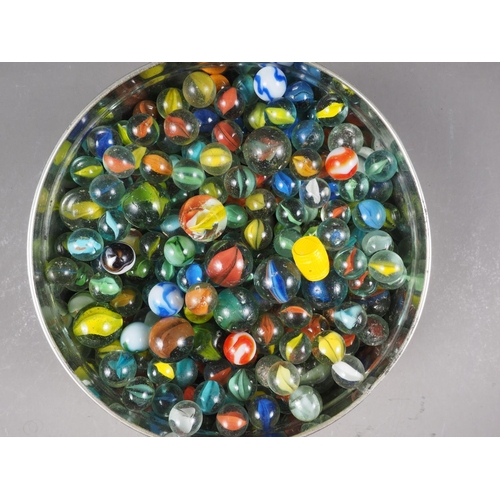 45 - A biscuit tin containing a collection of glass marbles