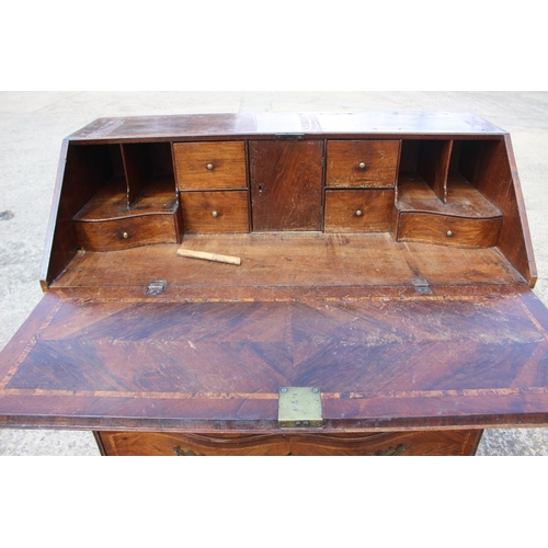 466 - An early 19th century Genoese walnut and banded serpentine front bureau with fitted interior over tw... 