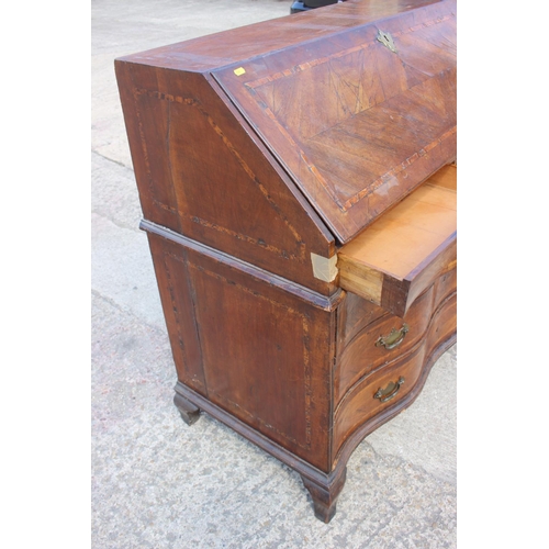 466 - An early 19th century Genoese walnut and banded serpentine front bureau with fitted interior over tw... 