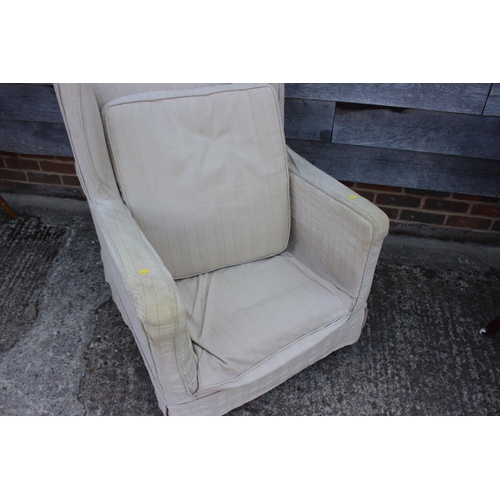 470 - A late 19th century square arm deep seat chair with loose seat cushion and linen covers, on turned c... 