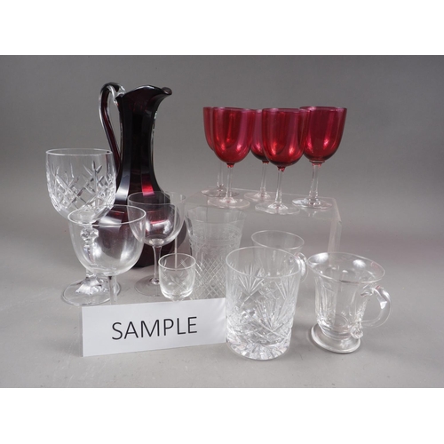 48 - A ruby and clear cut glass jug, whisky tumblers, wines and other glassware