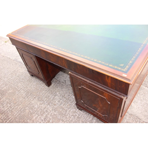 500 - A partners walnut double pedestal desk with green tooled leather lined top, fitted cupboards and dra... 