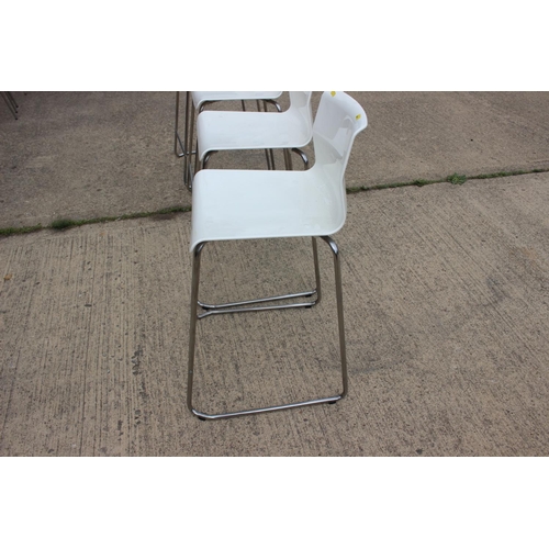 505 - A set of four chrome frame high seat stools with white acrylic seats