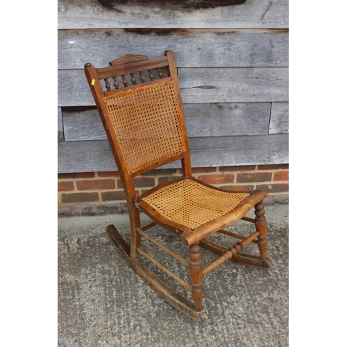 528 - An Edwardian polished as walnut cane seat and back rocking chair