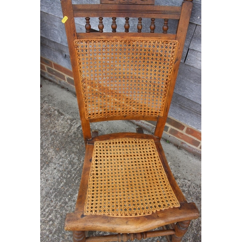 528 - An Edwardian polished as walnut cane seat and back rocking chair