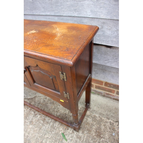 535 - A Titchmarsh & Goodwin oak side cupboard of 17th century design enclosed two ogee arch top panel... 