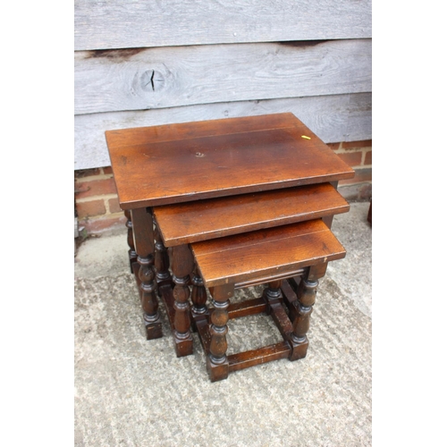 546 - A nest of three oak occasional tables, on turned and stretchered supports, 22