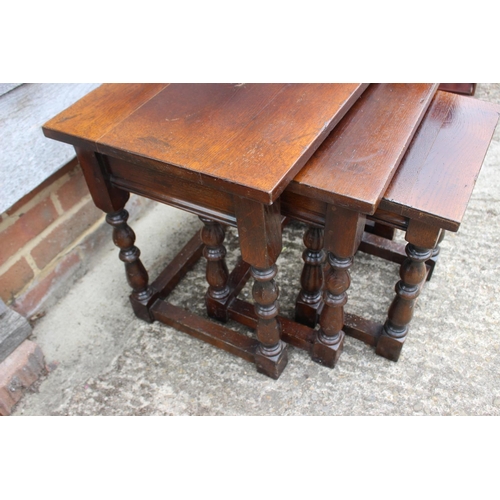 546 - A nest of three oak occasional tables, on turned and stretchered supports, 22