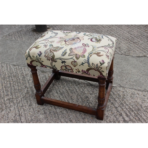 547 - A stool of 17th century design with crewel work type seat, on turned and stretchered supports, 20