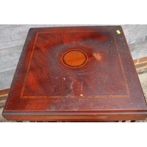 550 - A mahogany and inlaid revolving two-tier bookcase, 18