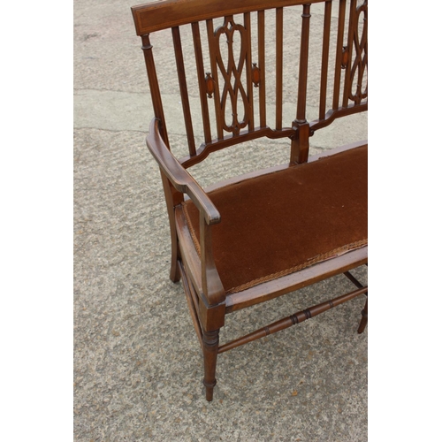 568 - A late 19th century walnut and line inlaid two-seat vertical rail back and pierced splat back settee... 