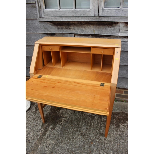 578 - A 1950s beech and lacewood fall front desk with fitted interior over two drawers with knob handles, ... 