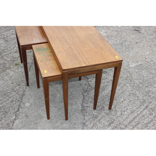 596 - A nest of three 1960s teak tables, on square taper supports, largest 33