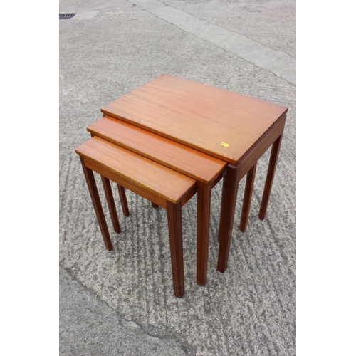 596 - A nest of three 1960s teak tables, on square taper supports, largest 33