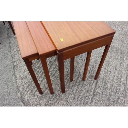 596 - A nest of three 1960s teak tables, on square taper supports, largest 33