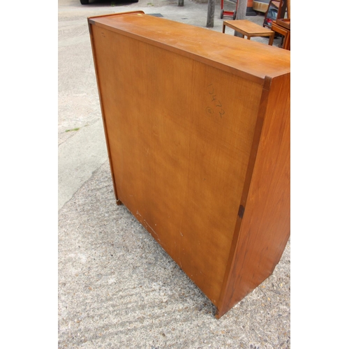 597 - A 1960s teak fall front bureau with fitted interior over two drawers and cupboards, 36