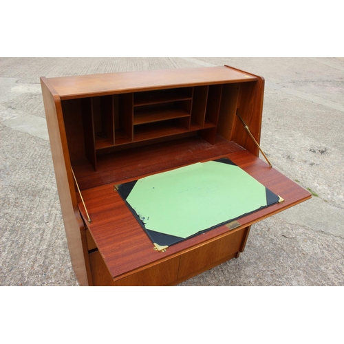 597 - A 1960s teak fall front bureau with fitted interior over two drawers and cupboards, 36