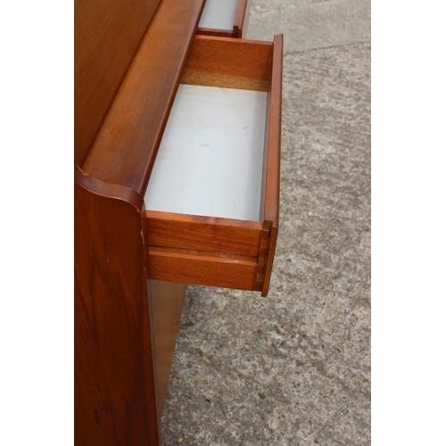 597 - A 1960s teak fall front bureau with fitted interior over two drawers and cupboards, 36