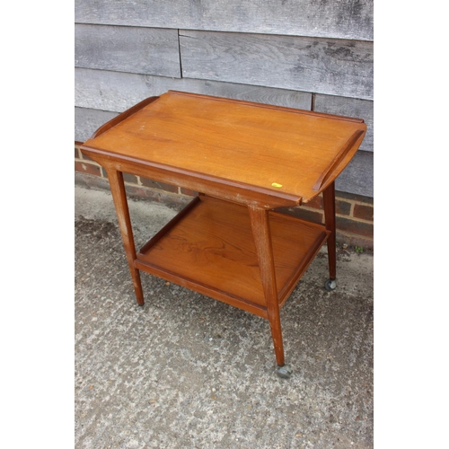 598 - A 1950s teak two-tier tea trolley, on splay supports, 30