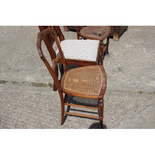 605 - A pair of 20th century carved walnut cane seat bedroom chairs and a similar chair