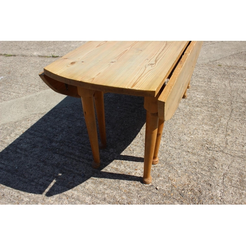 616 - A 19th century scrub top oval drop leaf kitchen table, on turned and tapered supports and pad feet, ... 