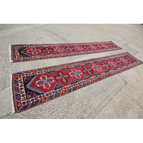 622 - A pair of Kazak wool runners with ten central medallions, in shades of red, blue and natural, 35