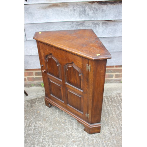 533 - A Titchmarsh & Goodwin oak corner cupboard of 17th century design enclosed four-panel door, on b... 